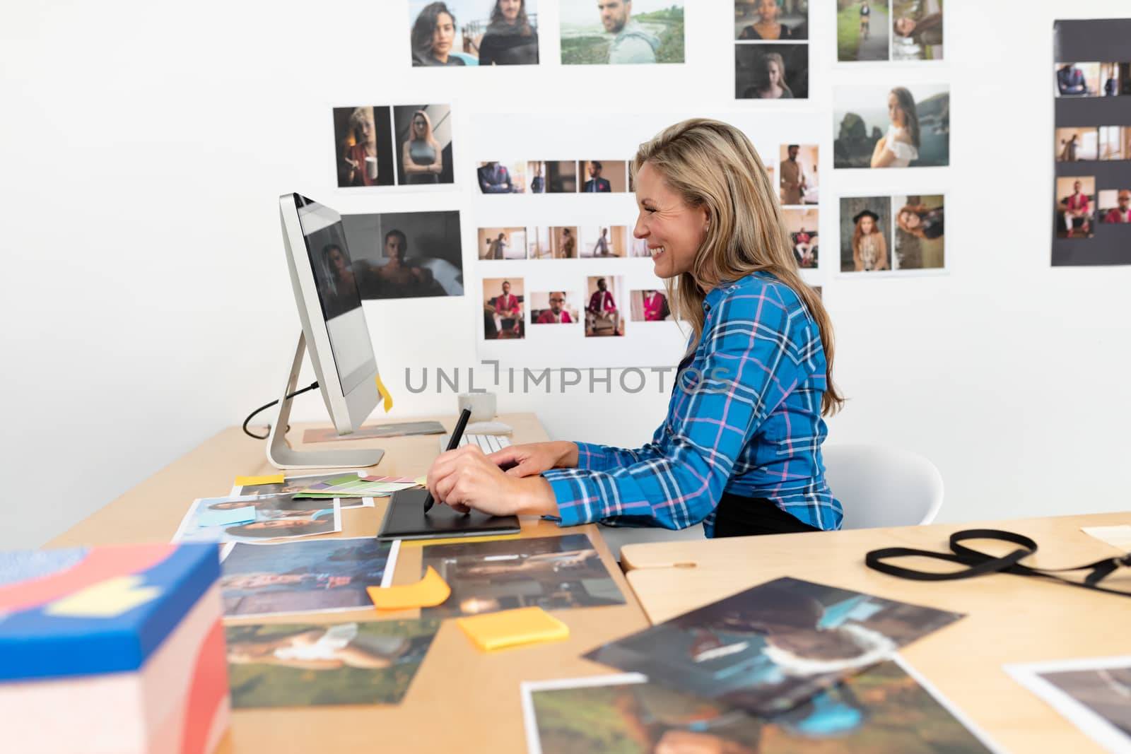 Female fashion designer using graphic tablet at desk by Wavebreakmedia