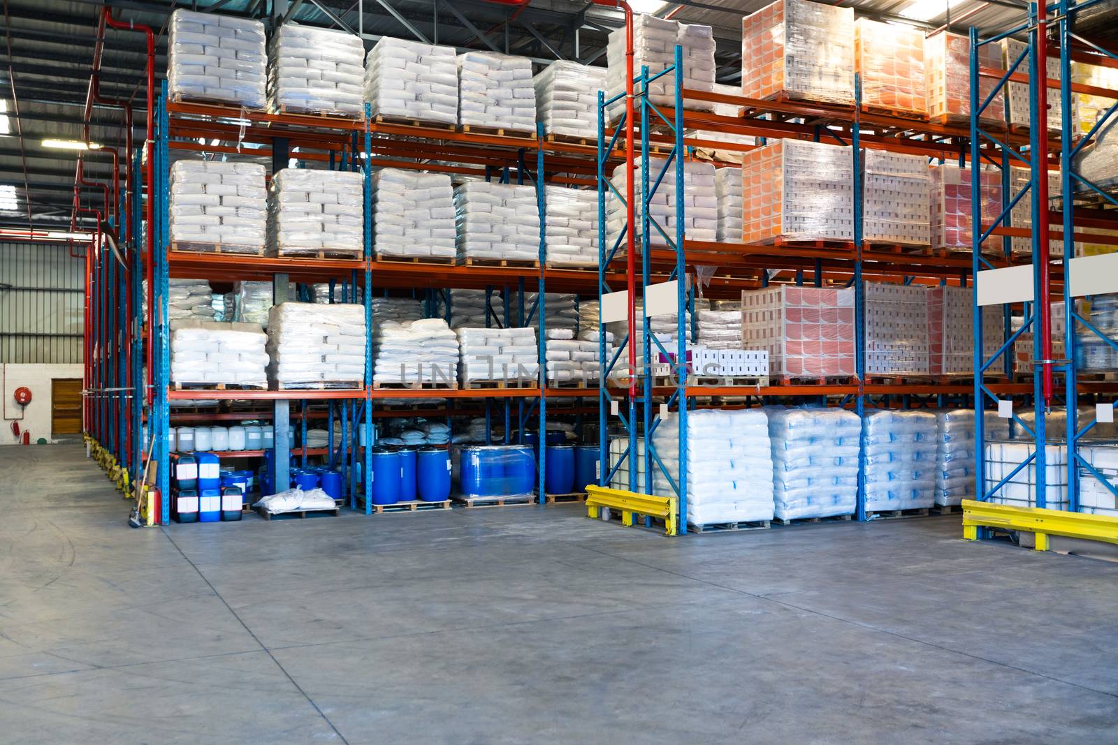 Barrel and goods arranged on a rack in warehouse. This is a freight transportation and distribution warehouse. Industrial and industrial workers concept