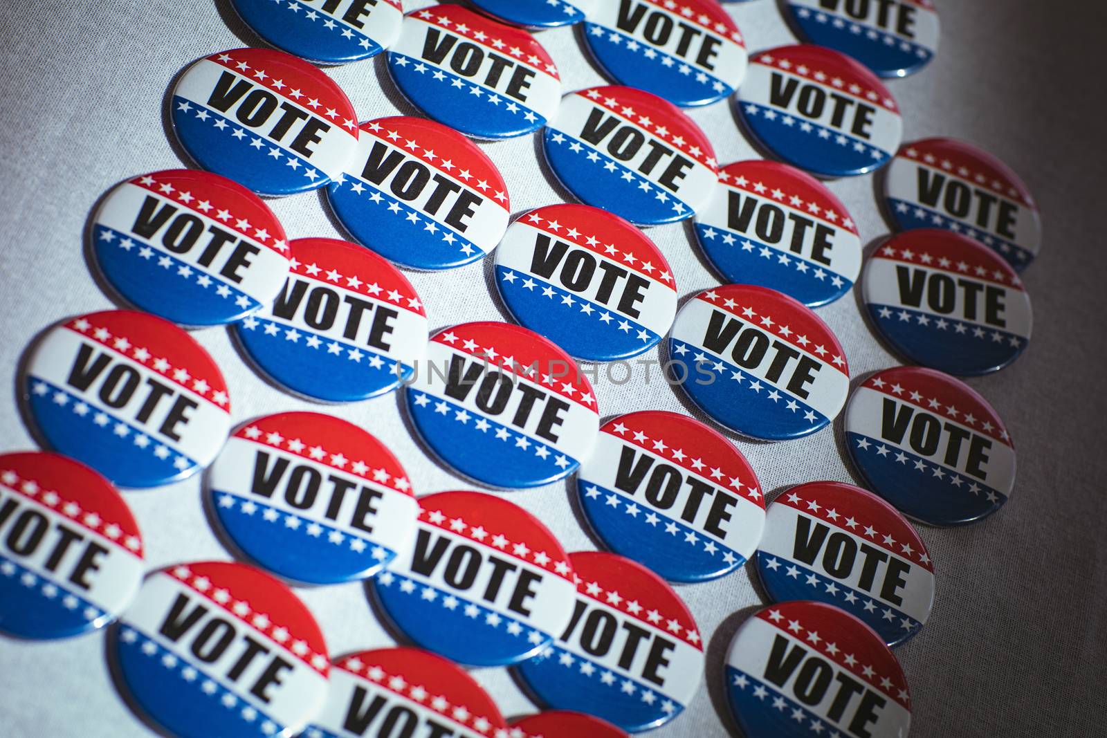 Electoral pins in the colors of the US flag on table