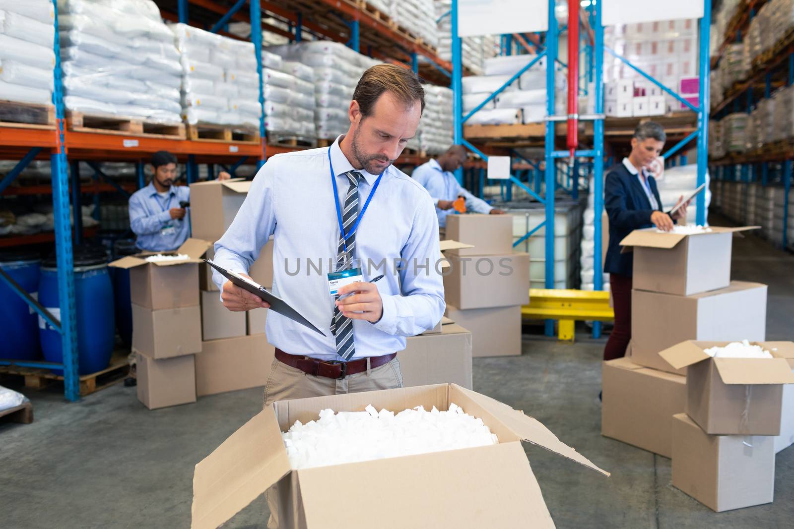 Male supervisor checking stocks in warehouse by Wavebreakmedia