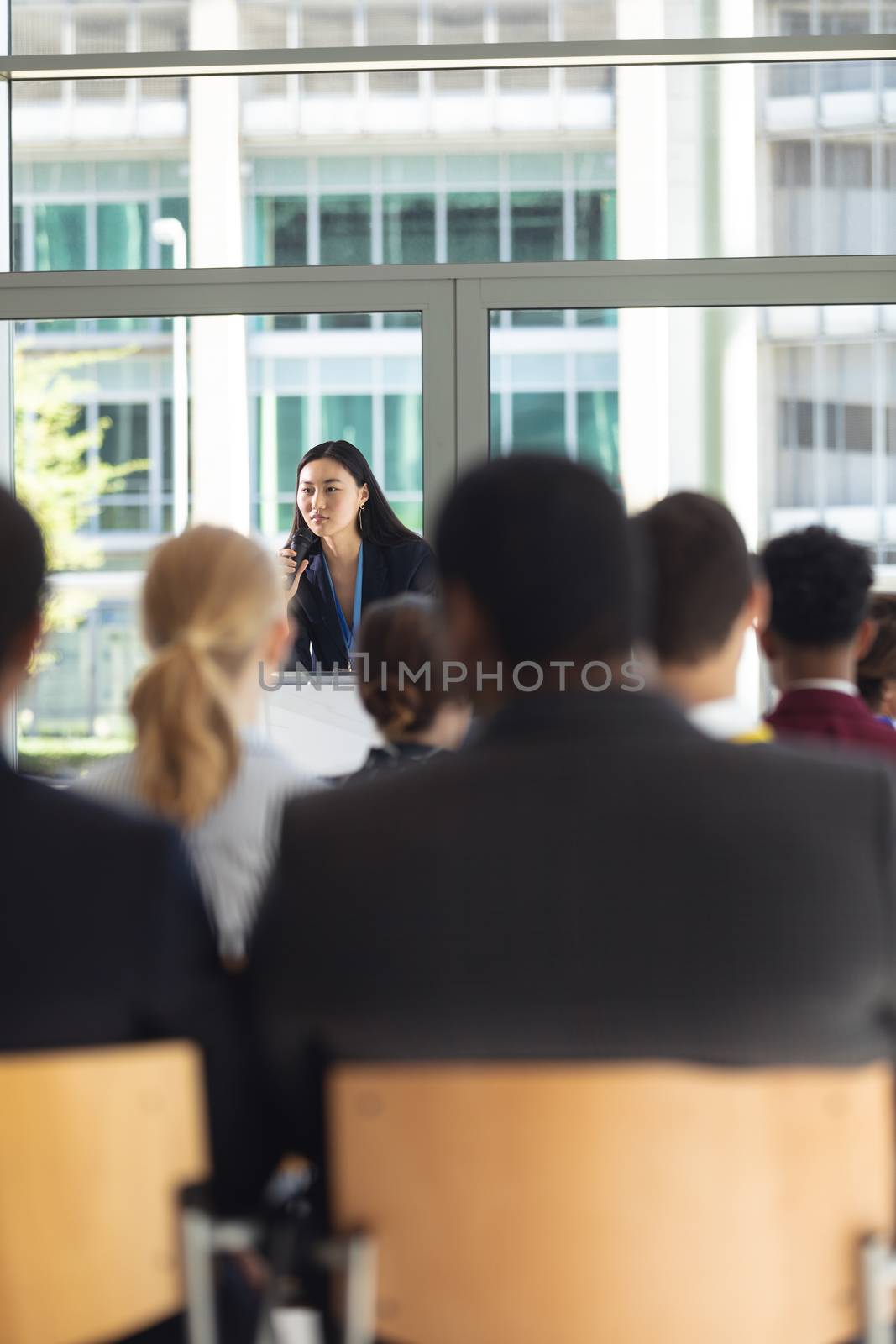 Young Asian female executive doing speech in conference room by Wavebreakmedia