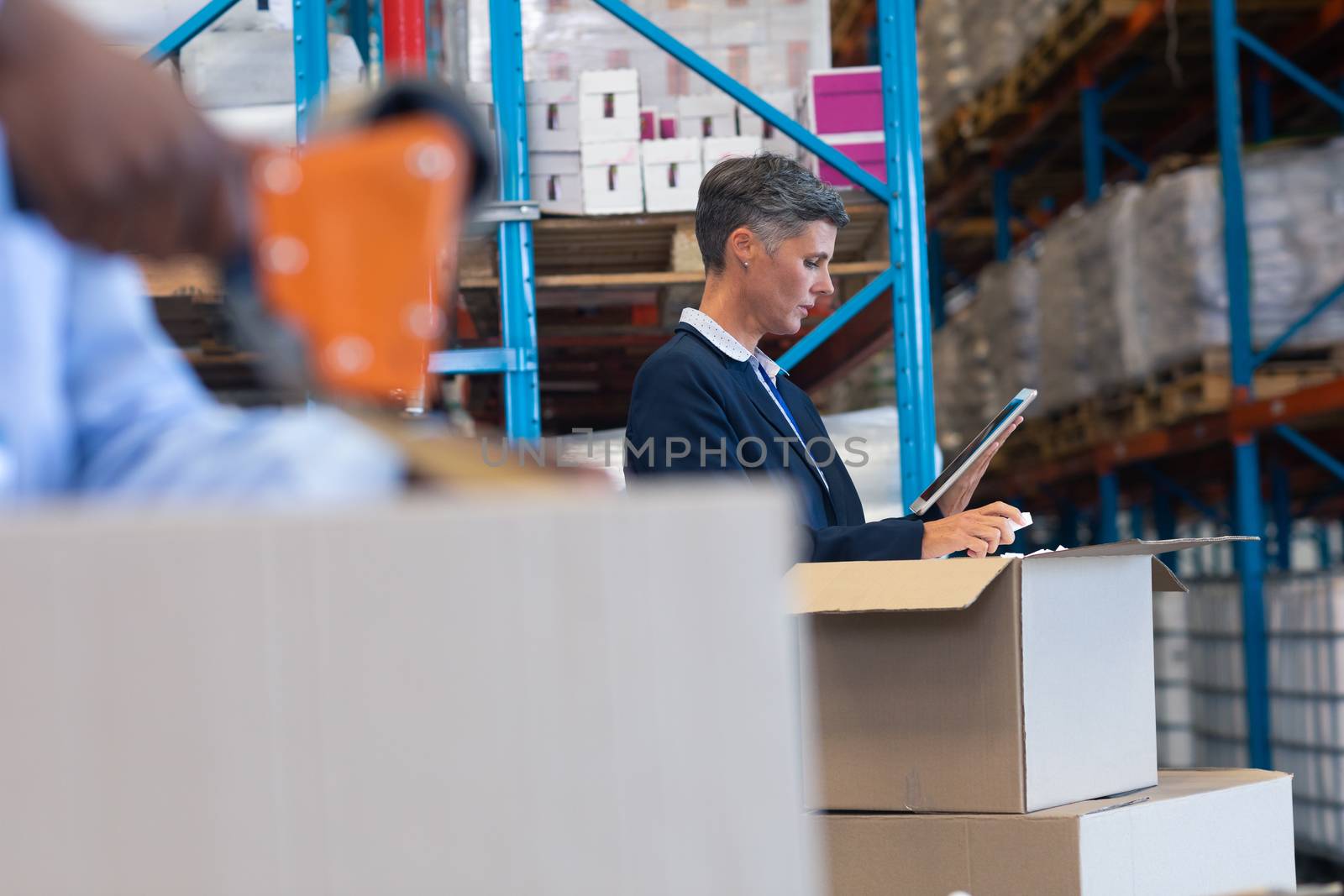 Female manager working on digital tablet in warehouse by Wavebreakmedia