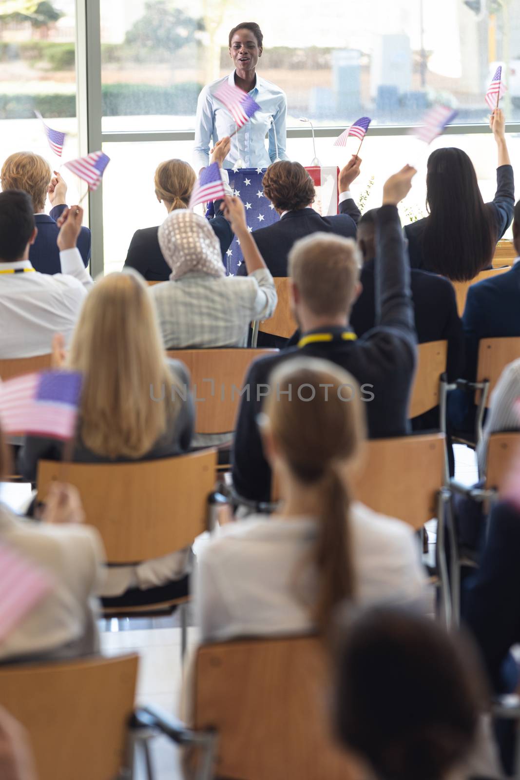 Young businesswoman doing speech and answering questions in conference room by Wavebreakmedia