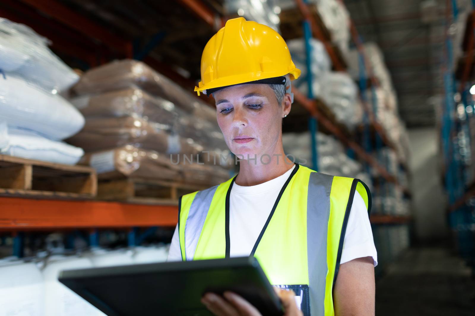 Female staff using digital tablet in warehouse by Wavebreakmedia