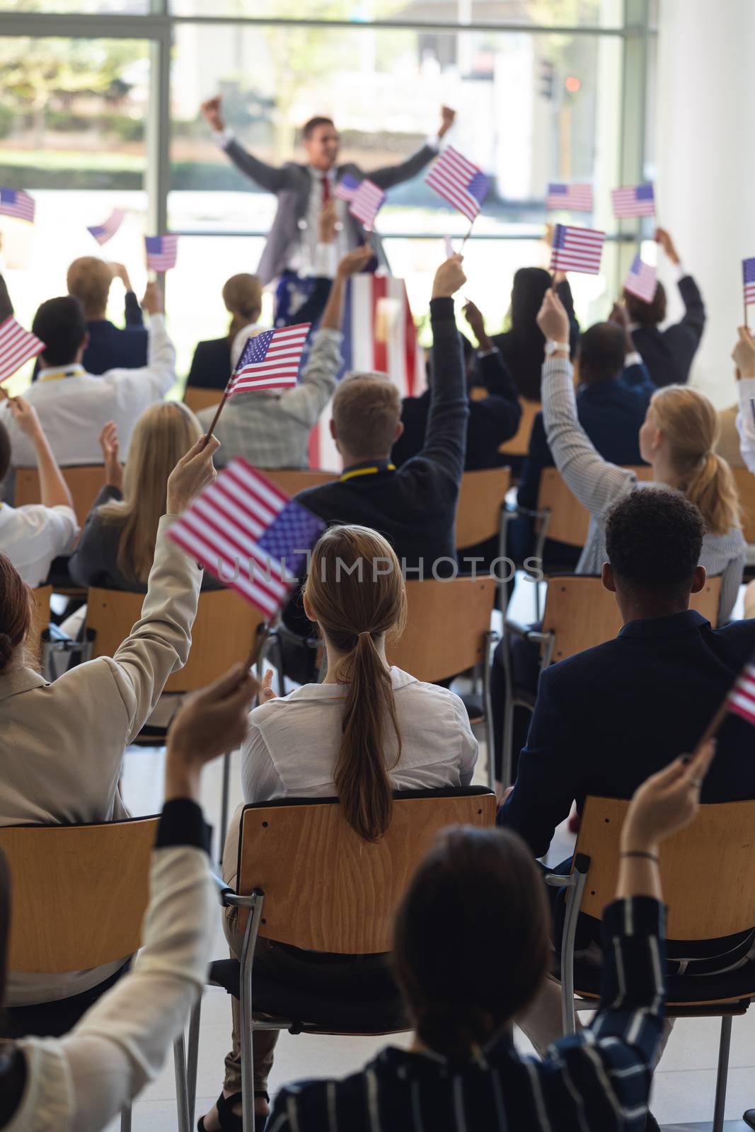 Businessman doing speech and celebrating victory in conference room by Wavebreakmedia