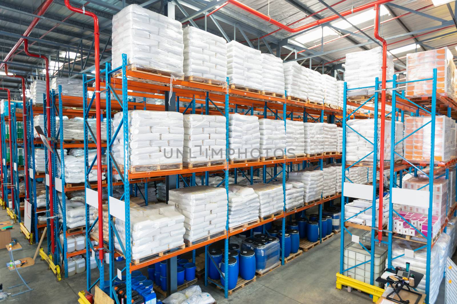 Barrel and goods arranged on a rack in warehouse by Wavebreakmedia