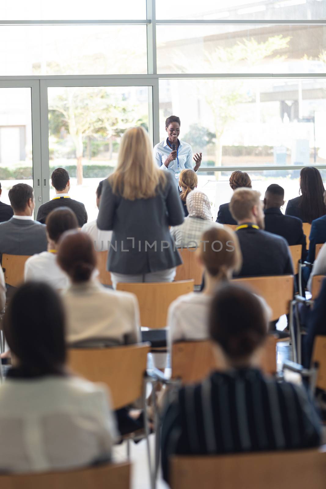 Young African american businesswoman doing speech and answering questions in conference room by Wavebreakmedia