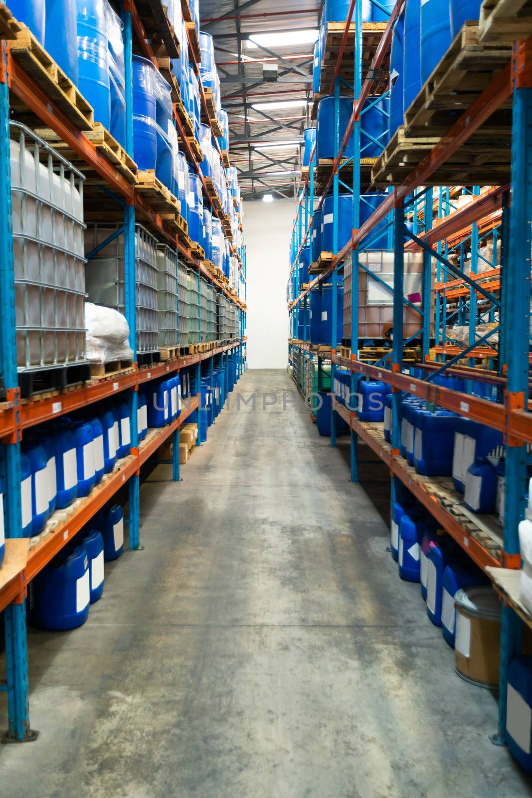 Barrel and crates arranged on a rack in warehouse. This is a freight transportation and distribution warehouse. Industrial and industrial workers concept