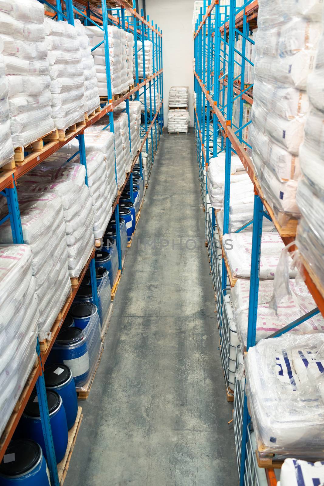 High angle view of barrel and goods arranged on a rack in warehouse. This is a freight transportation and distribution warehouse. Industrial and industrial workers concept