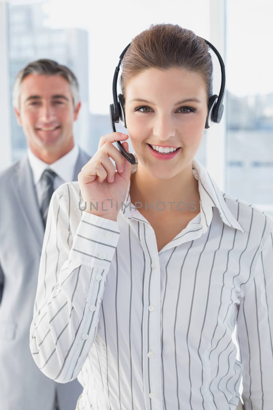 Businesswoman wearing a work headset with fellow employees