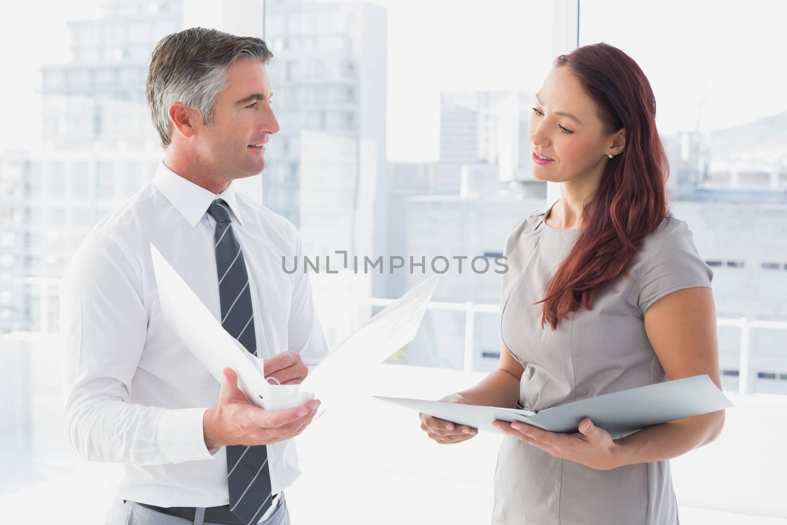 Business people smiling and talking at work