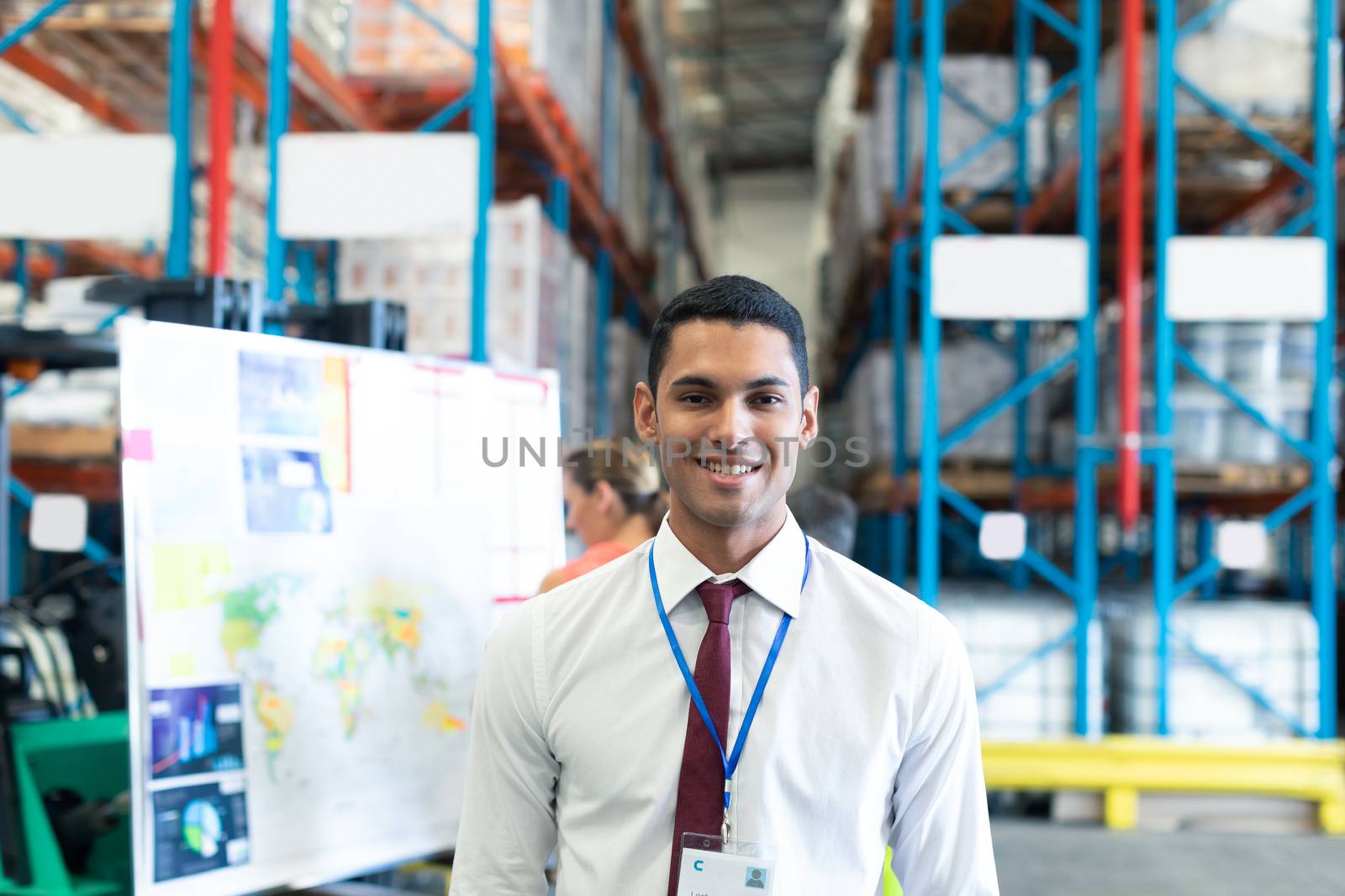 Portrait of happy Caucasian male staff looking at camera in warehouse. This is a freight transportation and distribution warehouse. Industrial and industrial workers concept