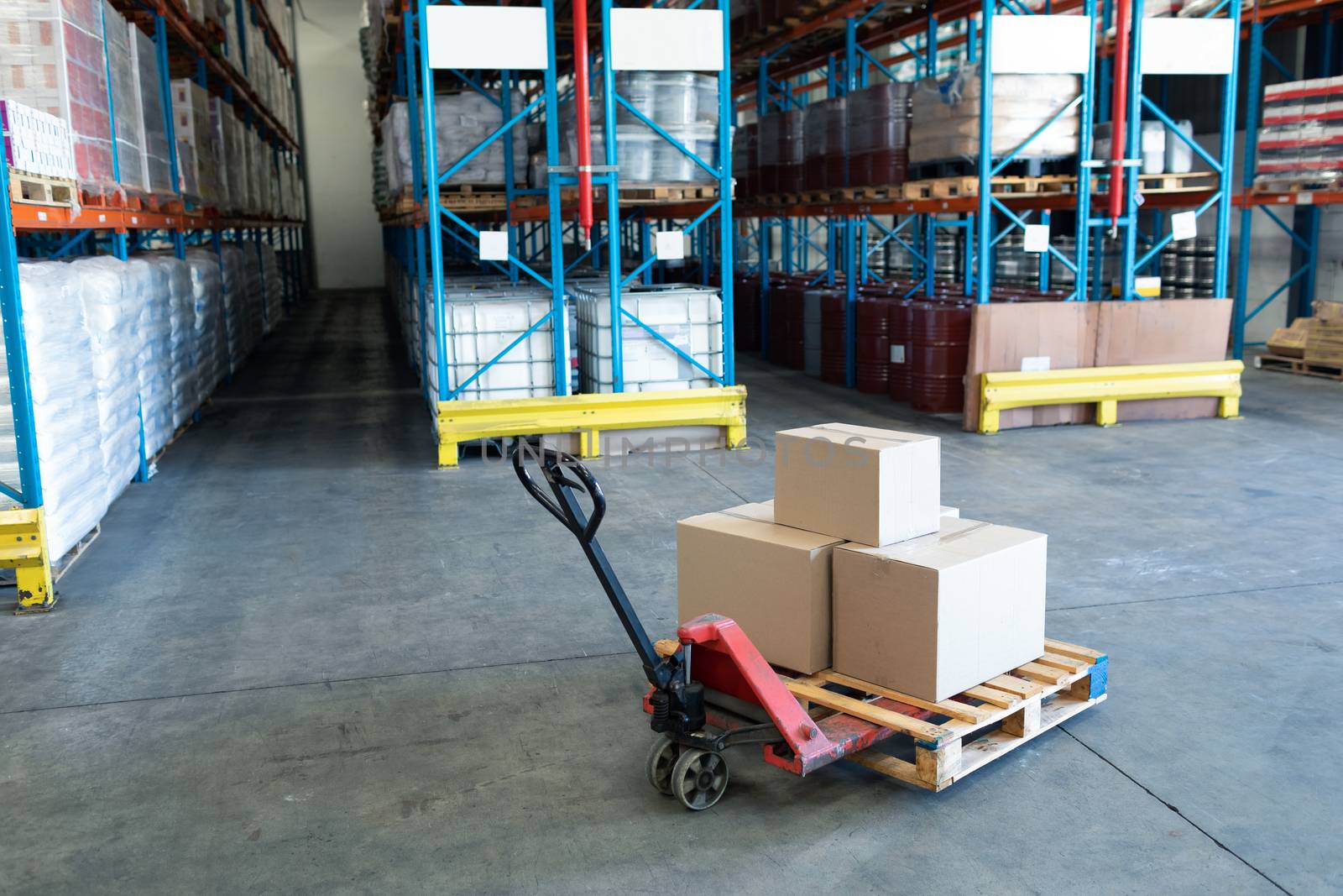 Cardboard boxes arranged on a pallet jack in warehouse. This is a freight transportation and distribution warehouse. Industrial and industrial workers concept