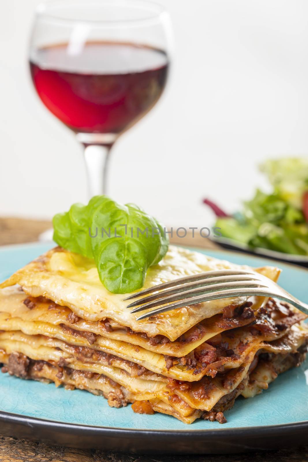 portion of fresh lasagna on a blue plate