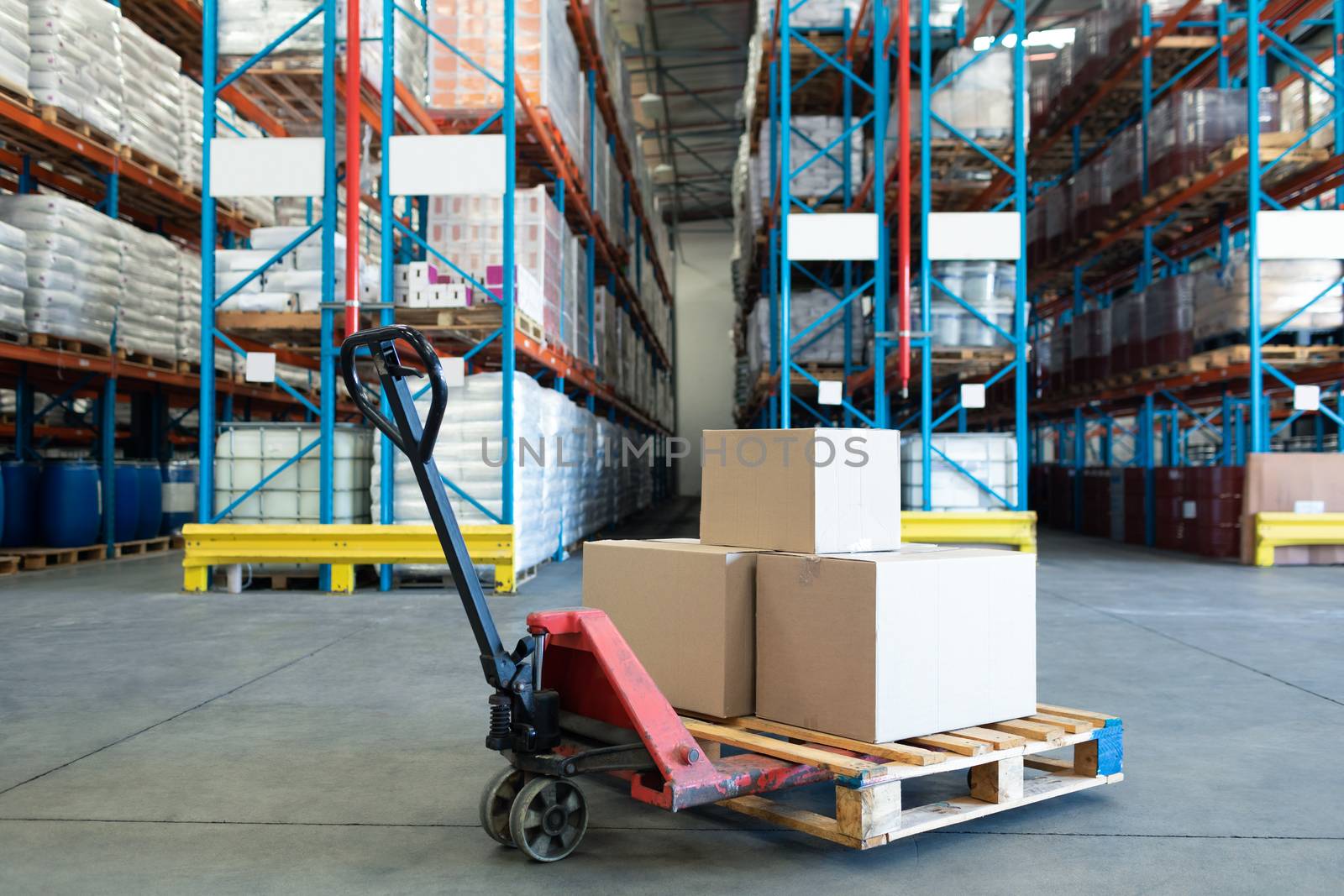 Cardboard boxes arranged on a pallet jack in warehouse. This is a freight transportation and distribution warehouse. Industrial and industrial workers concept