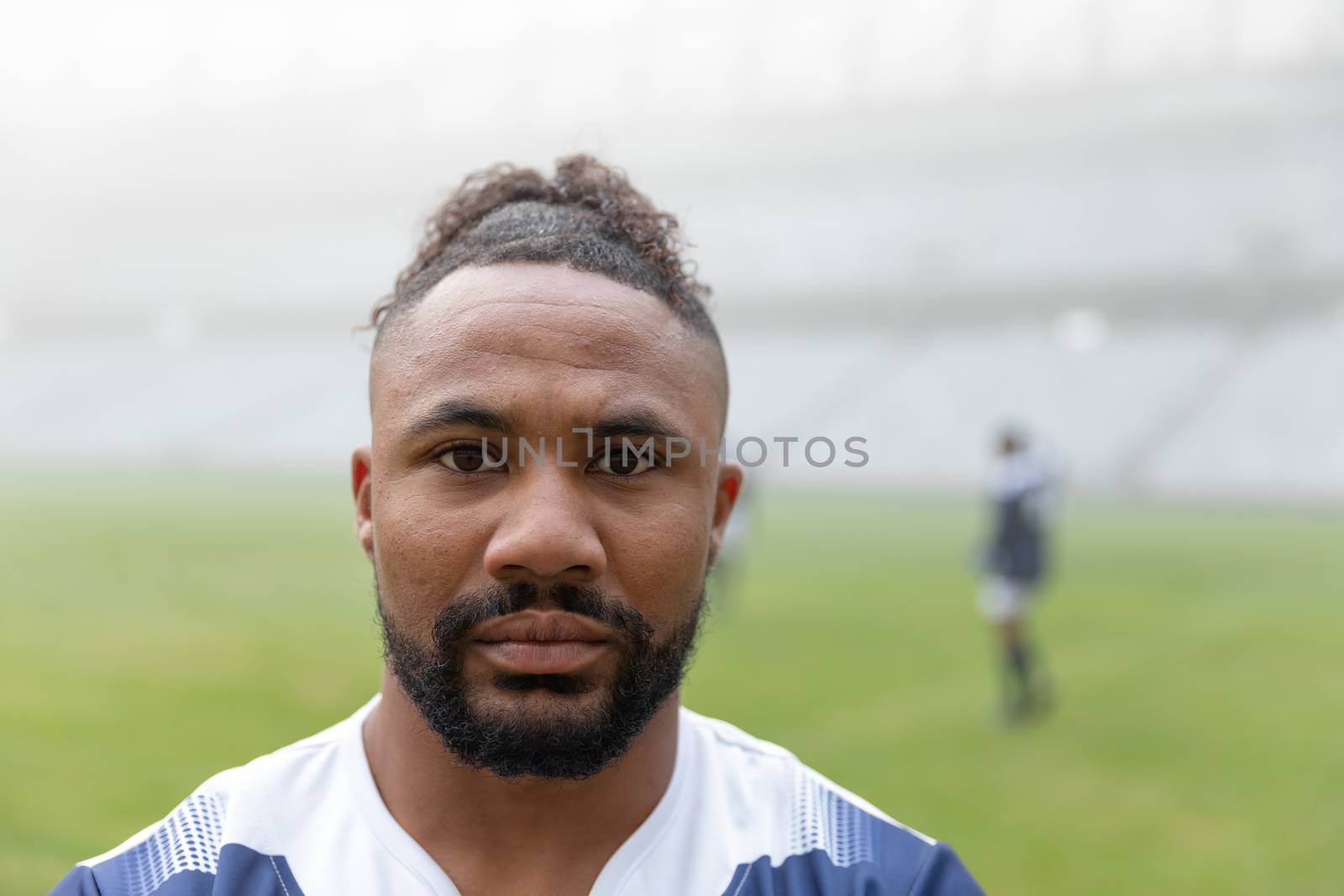 African american rugby player looking at camera in the stadium by Wavebreakmedia