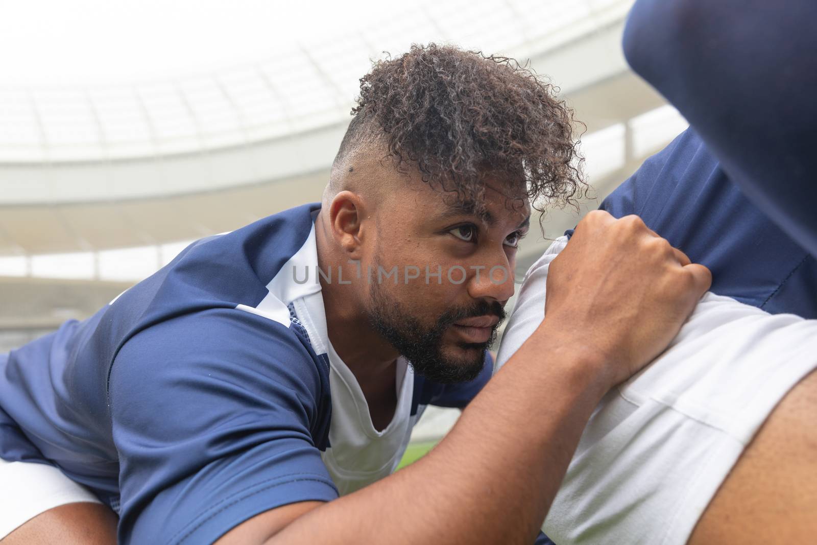 Side view of young African American male rugby players ready to play rugby match in stadium