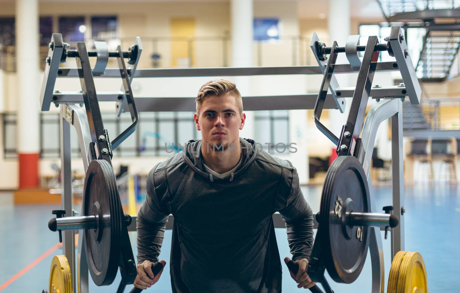 Man exercising with shoulder machine in fitness studio by Wavebreakmedia