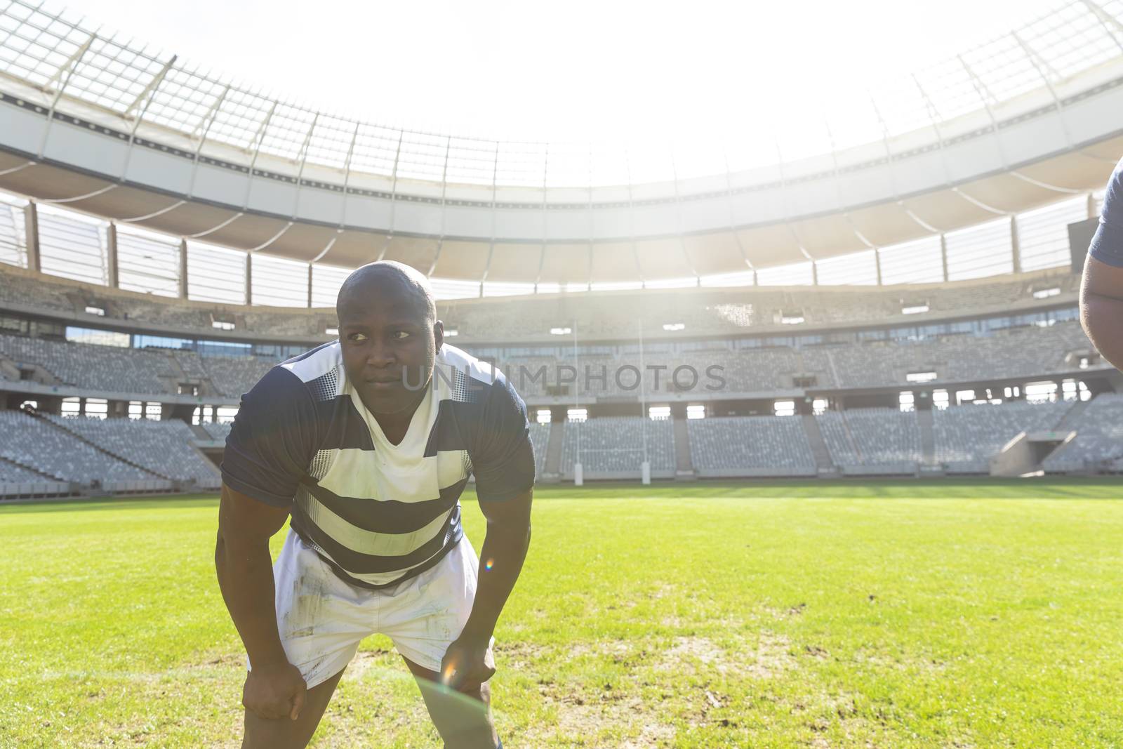 Male rugby player standing in stadium by Wavebreakmedia