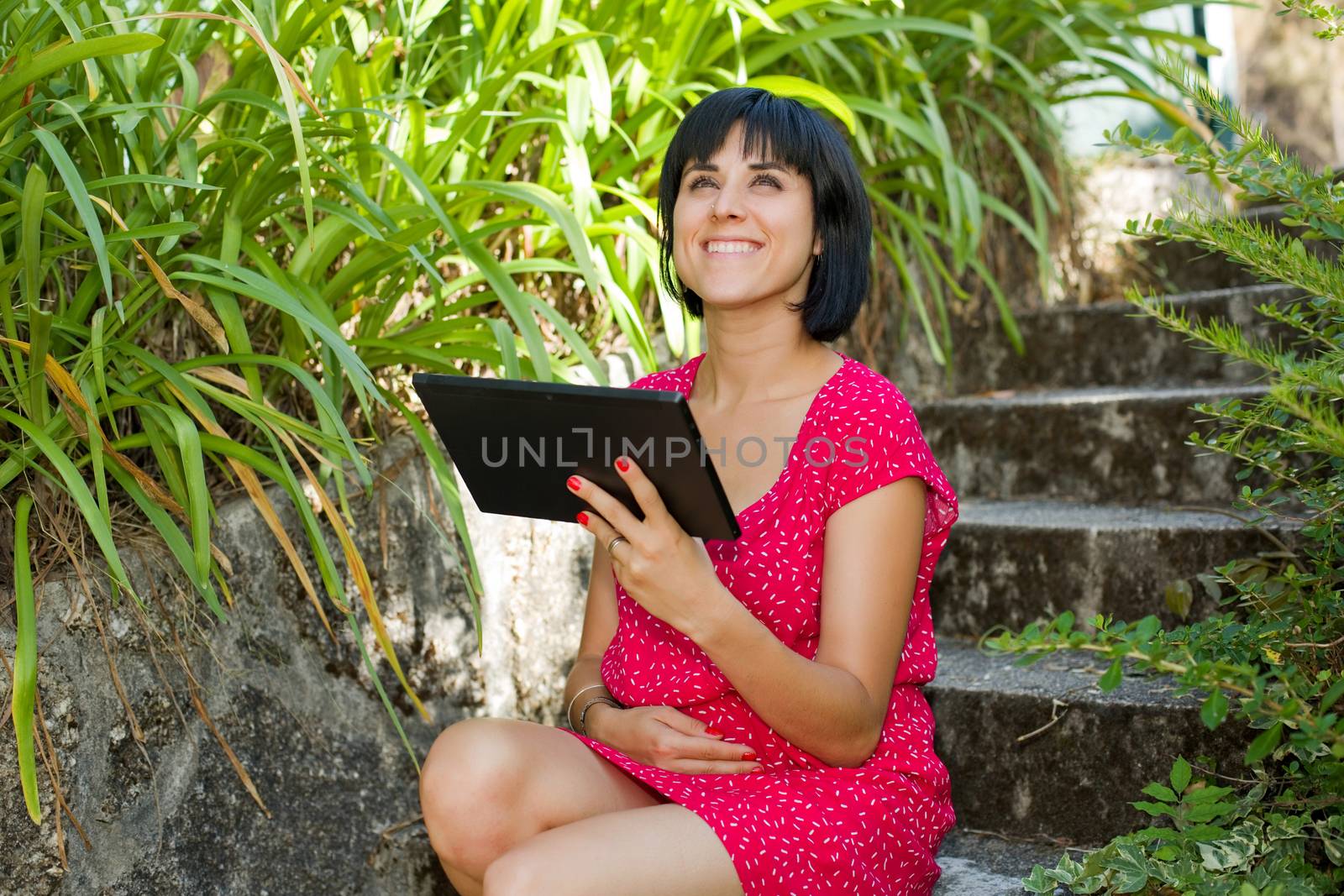 casual woman working with a tablet pc, outdoor