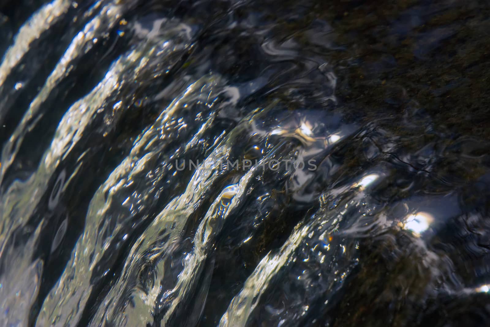 Closeup shot of crystal clear water reflecting the sun by definitearts