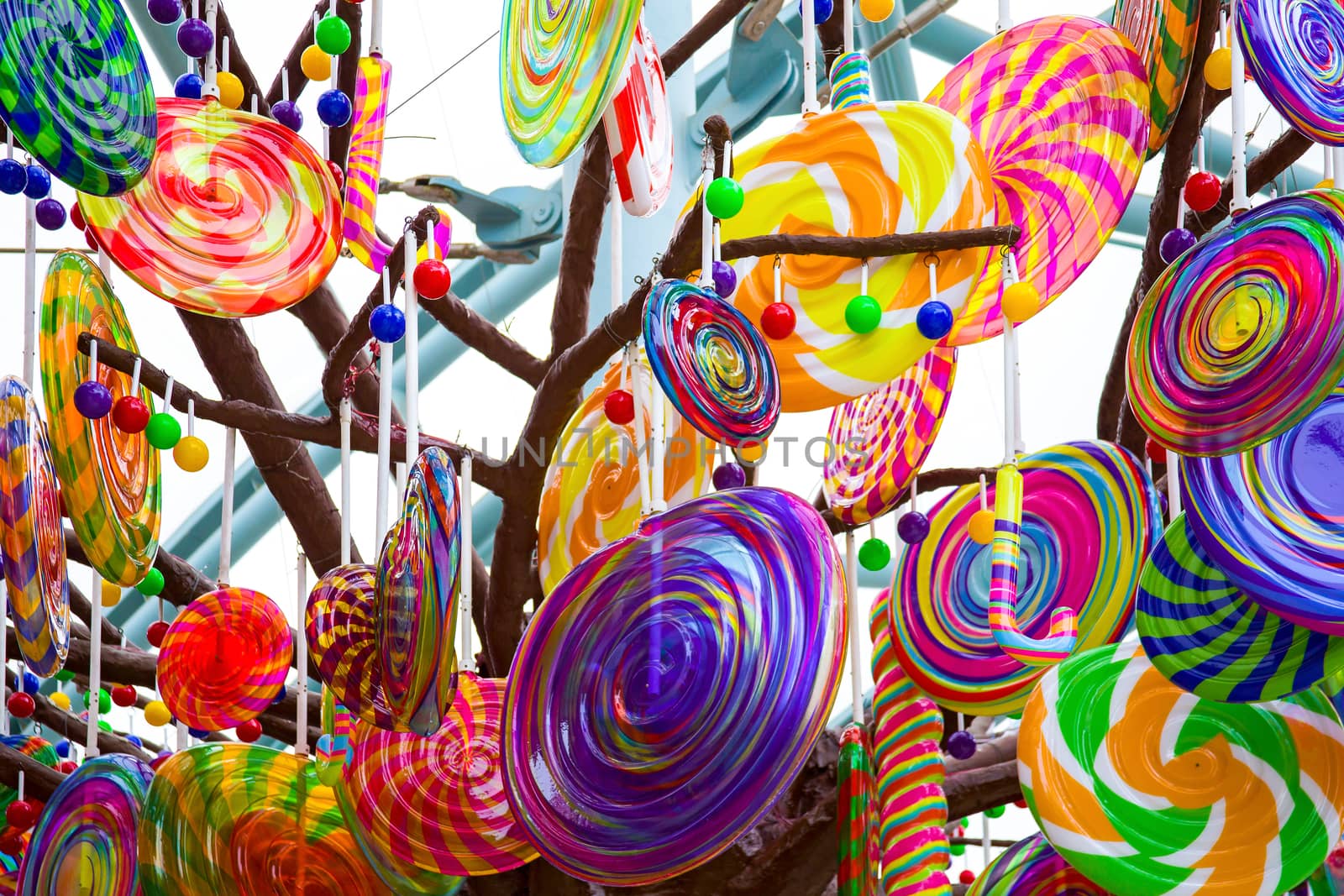 Colorful lollipops and different colored round candy. View from below.