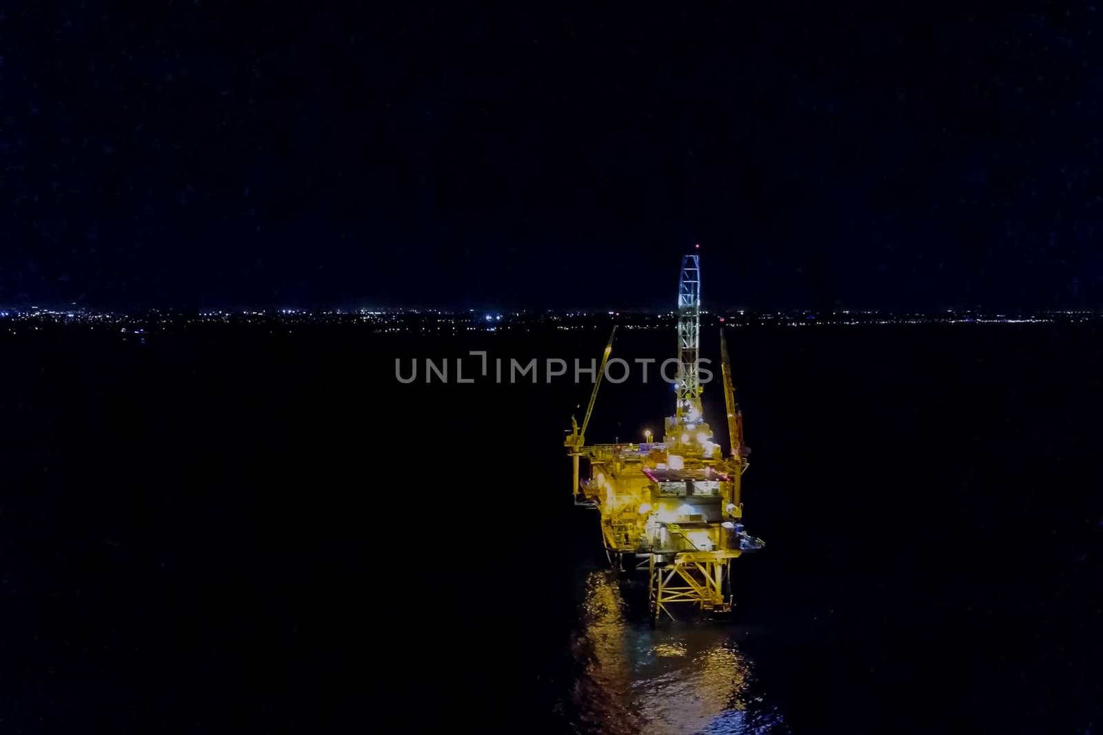 Oil platform at night in the light of its own lighting. Towing o by nyrok