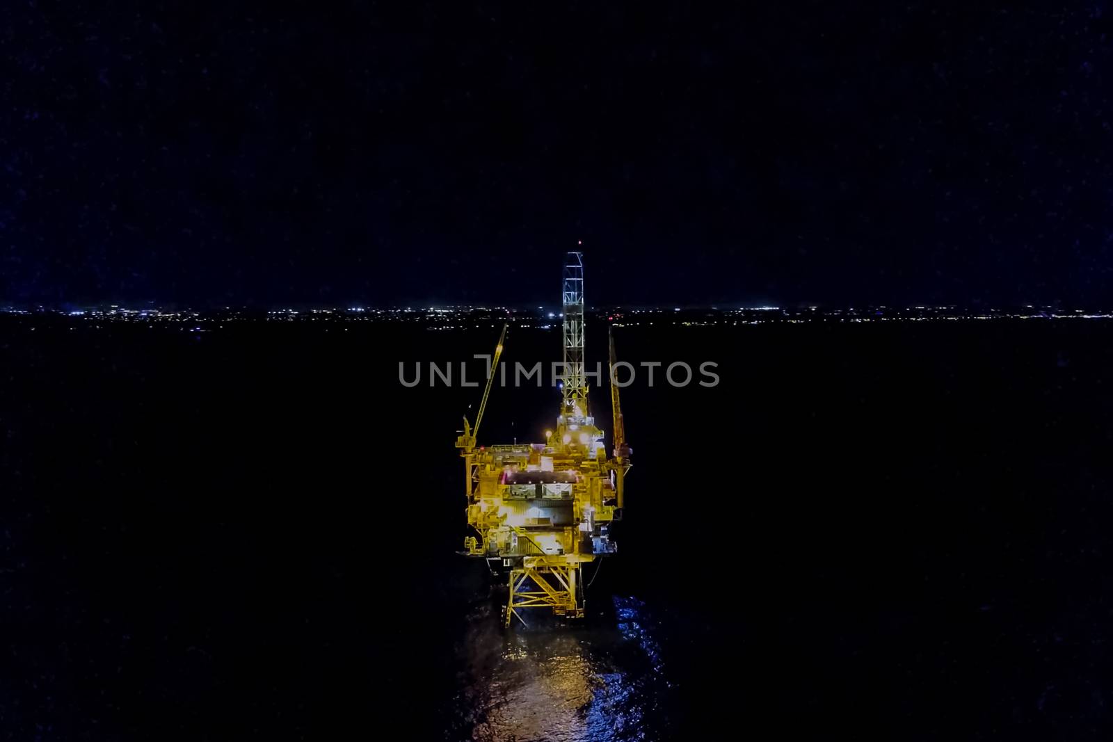 Oil platform at night in the light of its own lighting. Towing o by nyrok