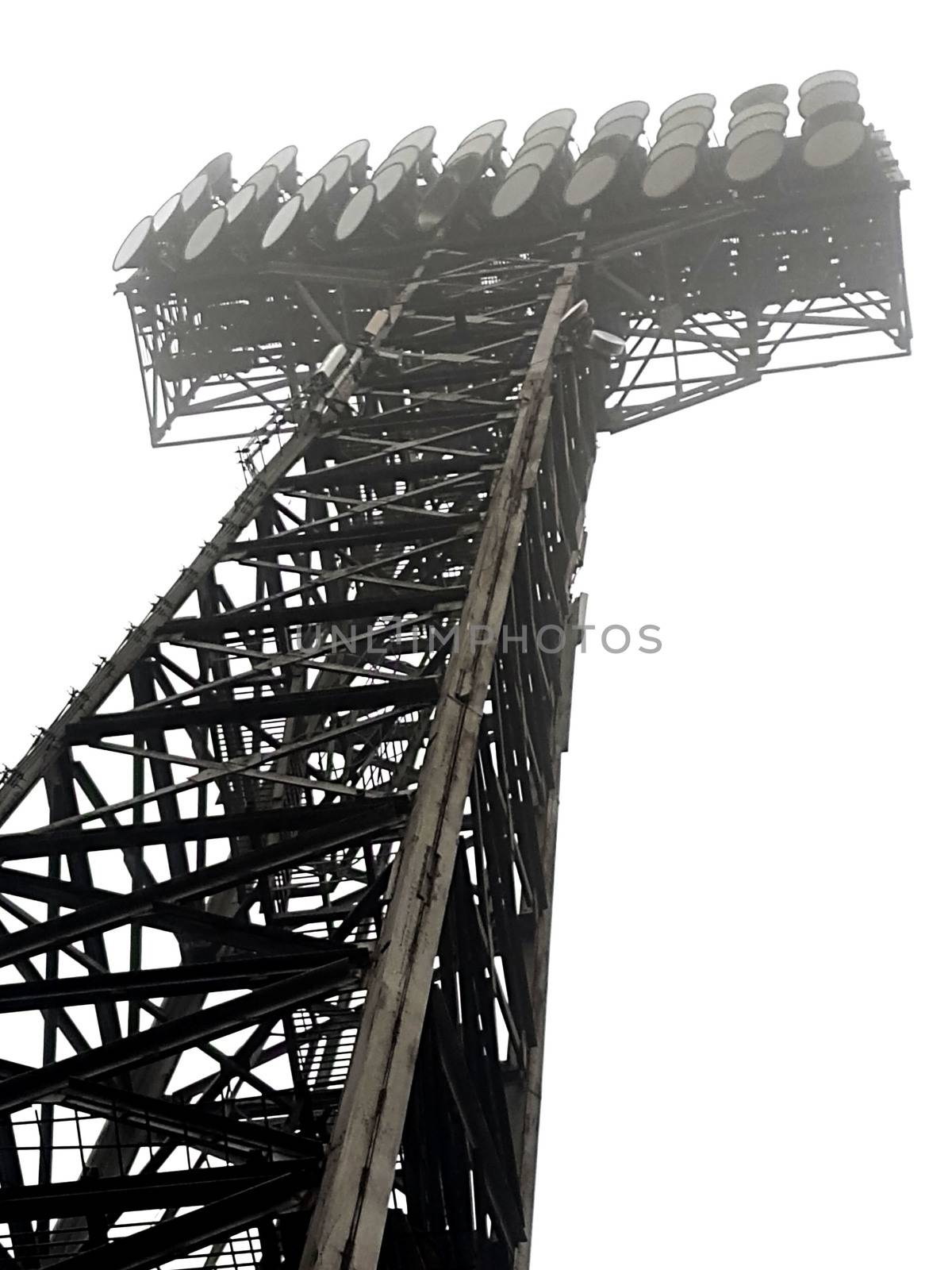 Tower with lighting for the stadium against the sky. Lanterns on the sky background.