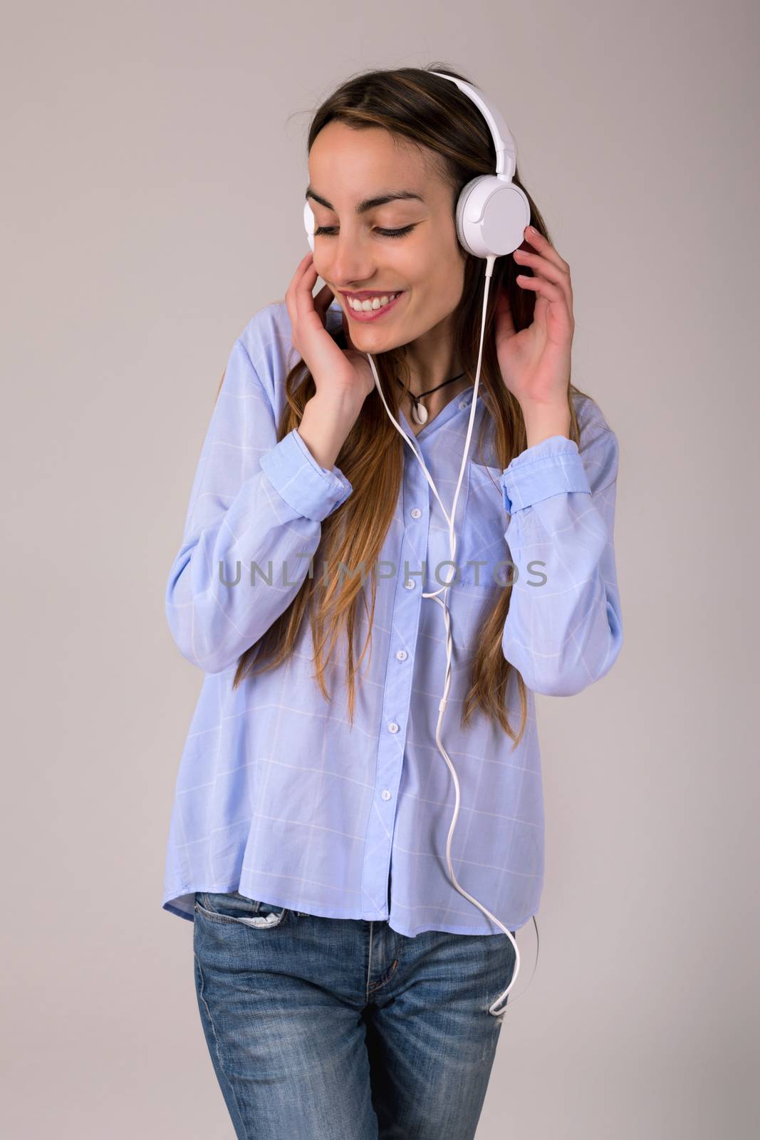 Beautiful young woman listen music with headphones