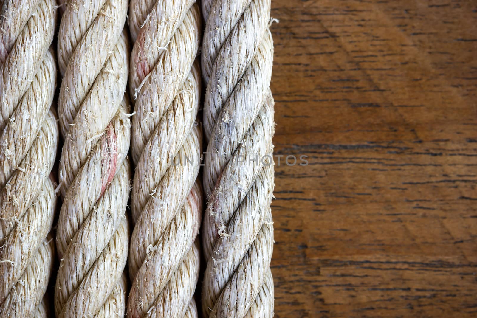 Rope vintage on brown wood background. Closeup and copy space. by SaitanSainam