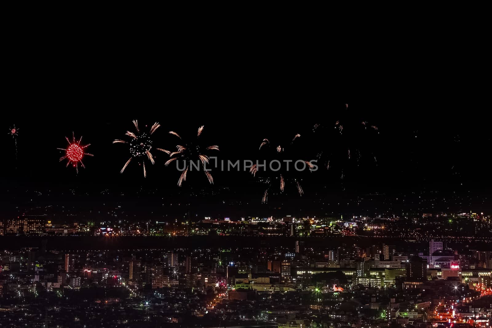 Festive salute in the night sky. Salute over the city the megalopolis. Explosions of fireworks.