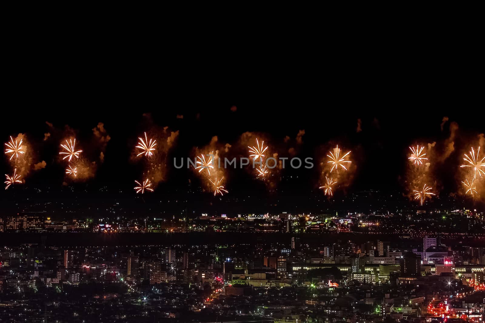 Festive salute in the night sky. Salute over the city the megalopolis. Explosions of fireworks.