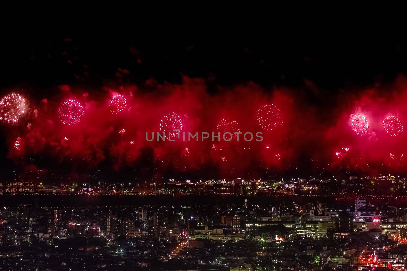 Festive salute in the night sky. Salute over the city the megalopolis. Explosions of fireworks.