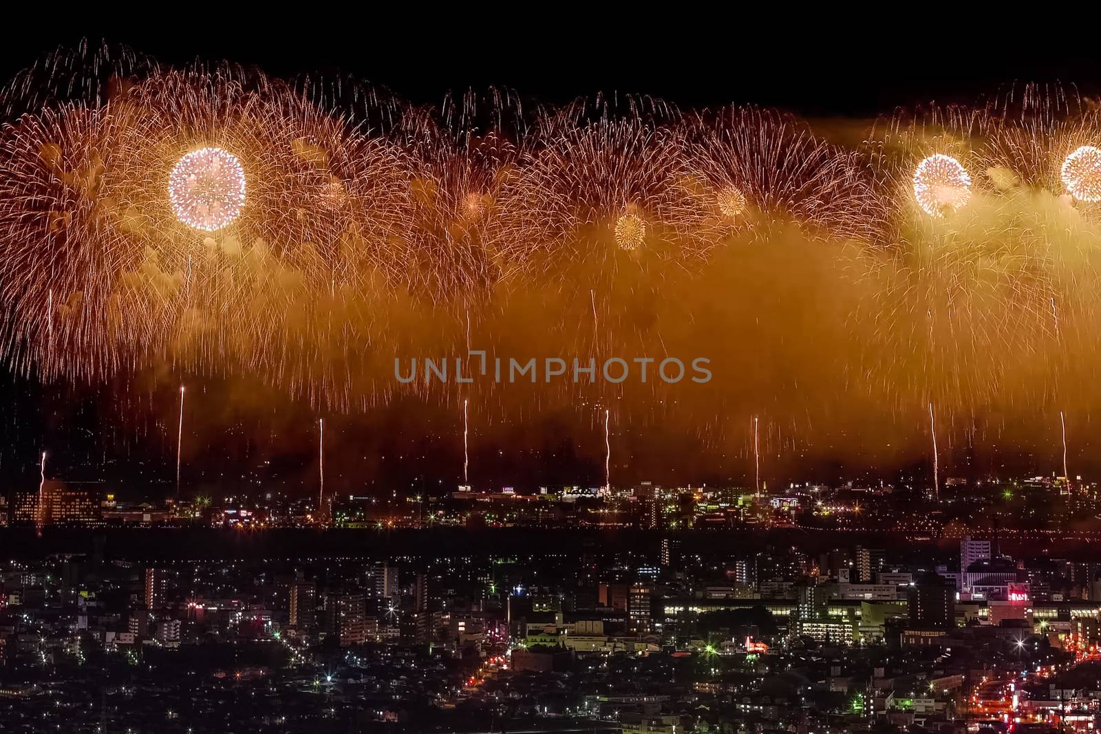 Festive salute in the night sky. Salute over the city the megalopolis. Explosions of fireworks.