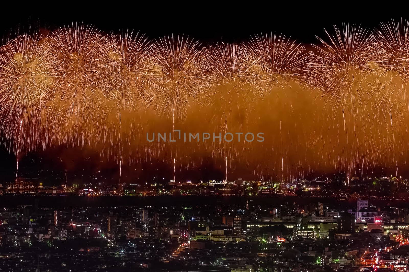 Festive salute in the night sky. Salute over the city the megalopolis. Explosions of fireworks.