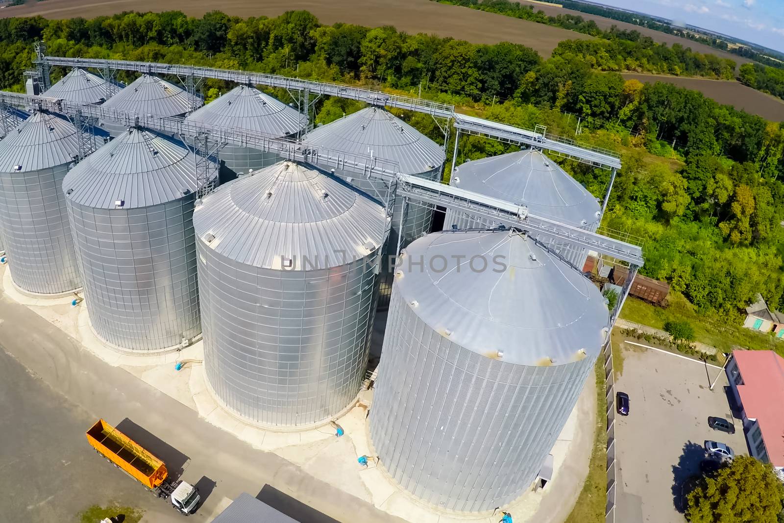 Flight of the grain terminal from the drone. The grain plant for storage and drying of grain. Grain terminal. Plant for the drying and storage Rice plant in the middle of fields by nyrok