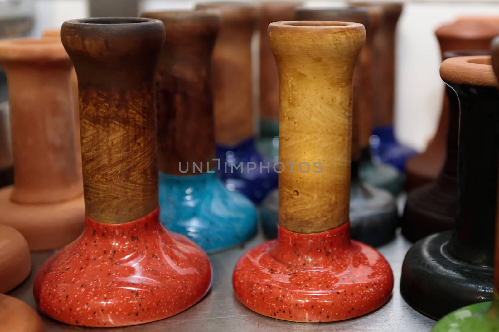 Close-up mouthpieces of different wood species stand in rows prepared for the hookah cooking process. Selective focus.