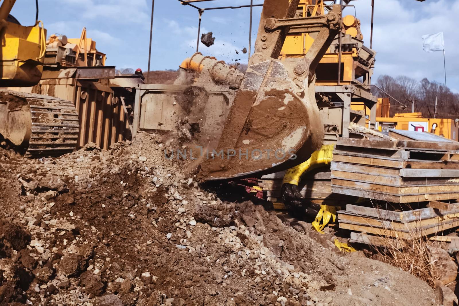 Bulldozer bucket. A bulldozer digs a hole.