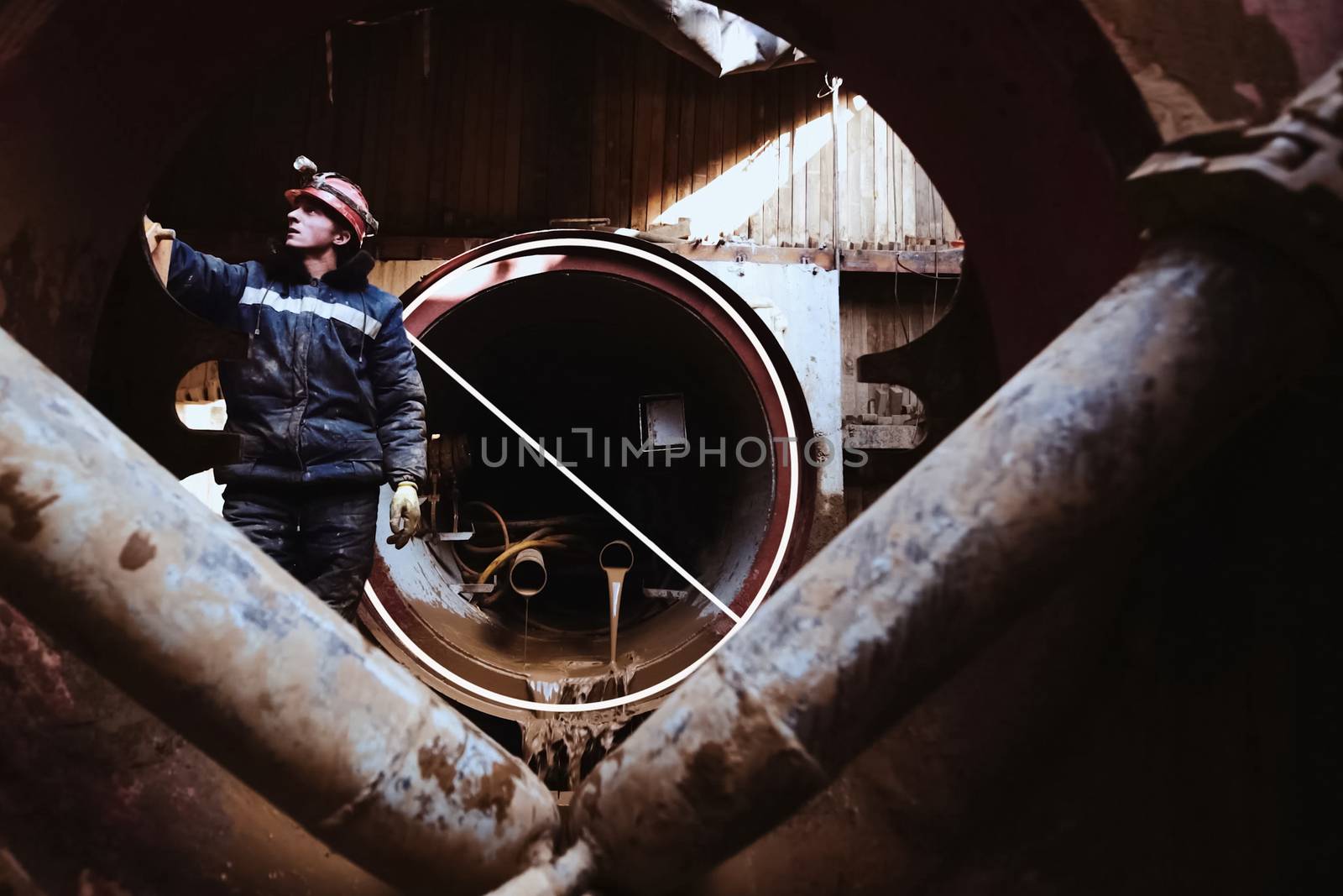 Irkutsk, Russia - March 24, 2017: The worker stands near the pipeline under construction.