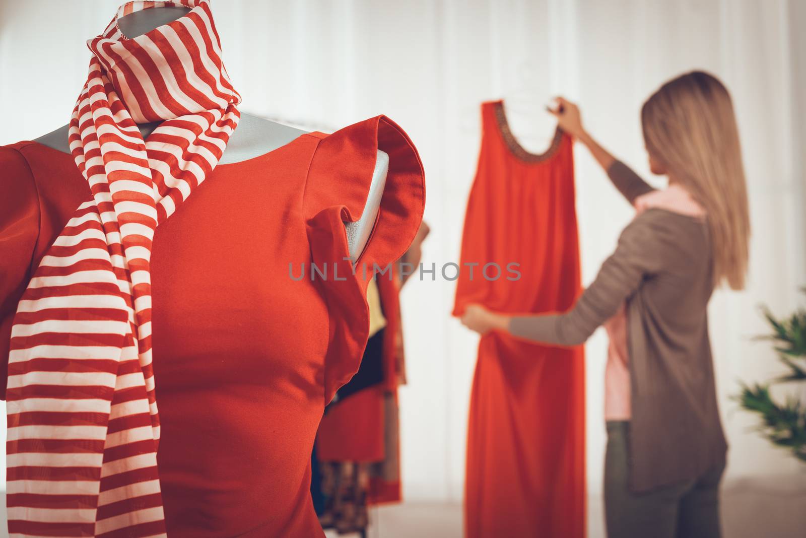 Close-up of a dress on mannequin in fashion designer office.