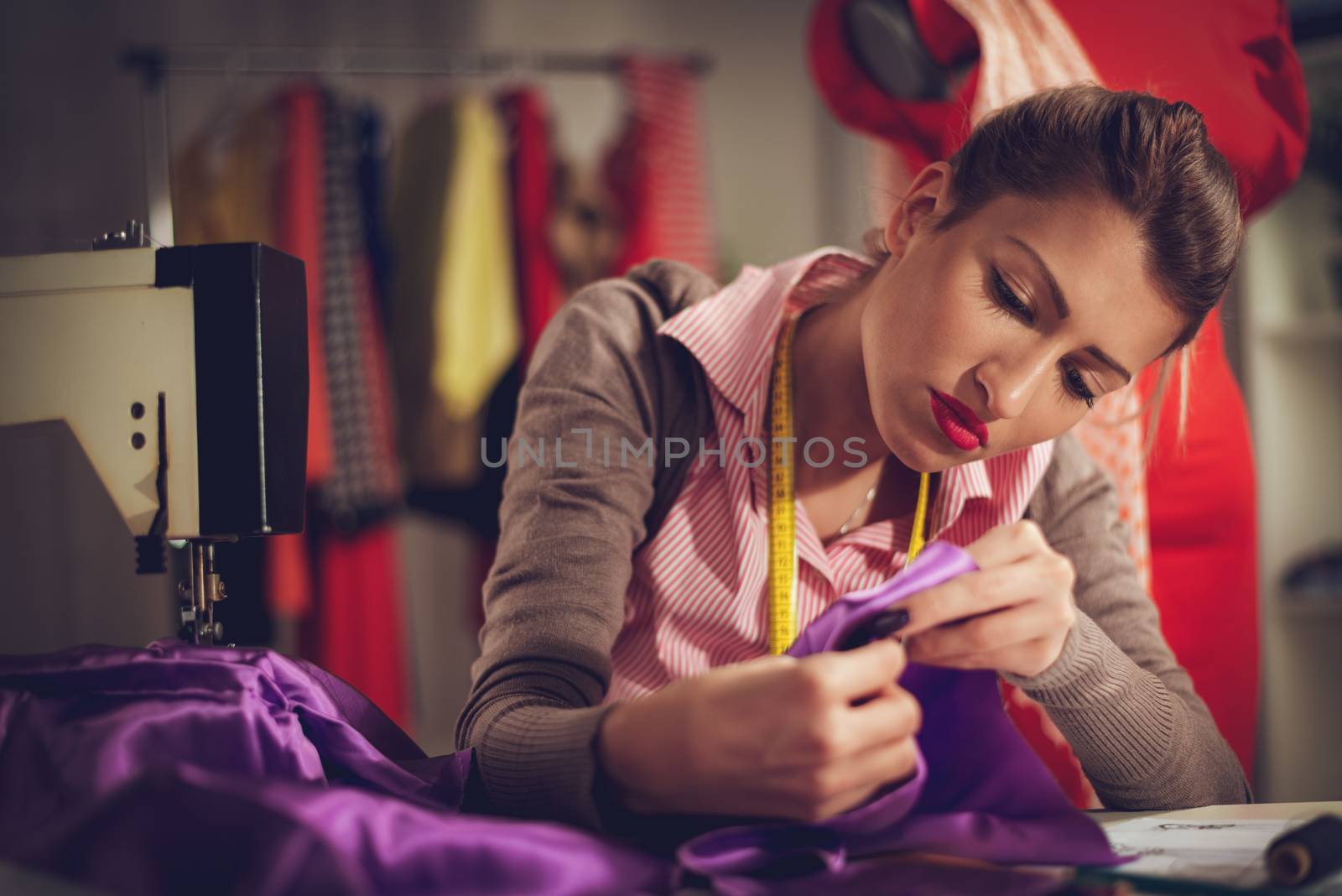 Young Woman Tailor Sewing by MilanMarkovic78