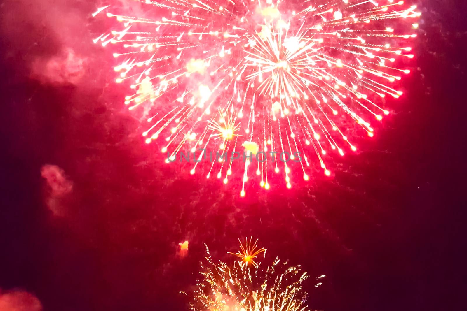 Festive salute in the night sky. Explosions of fireworks.