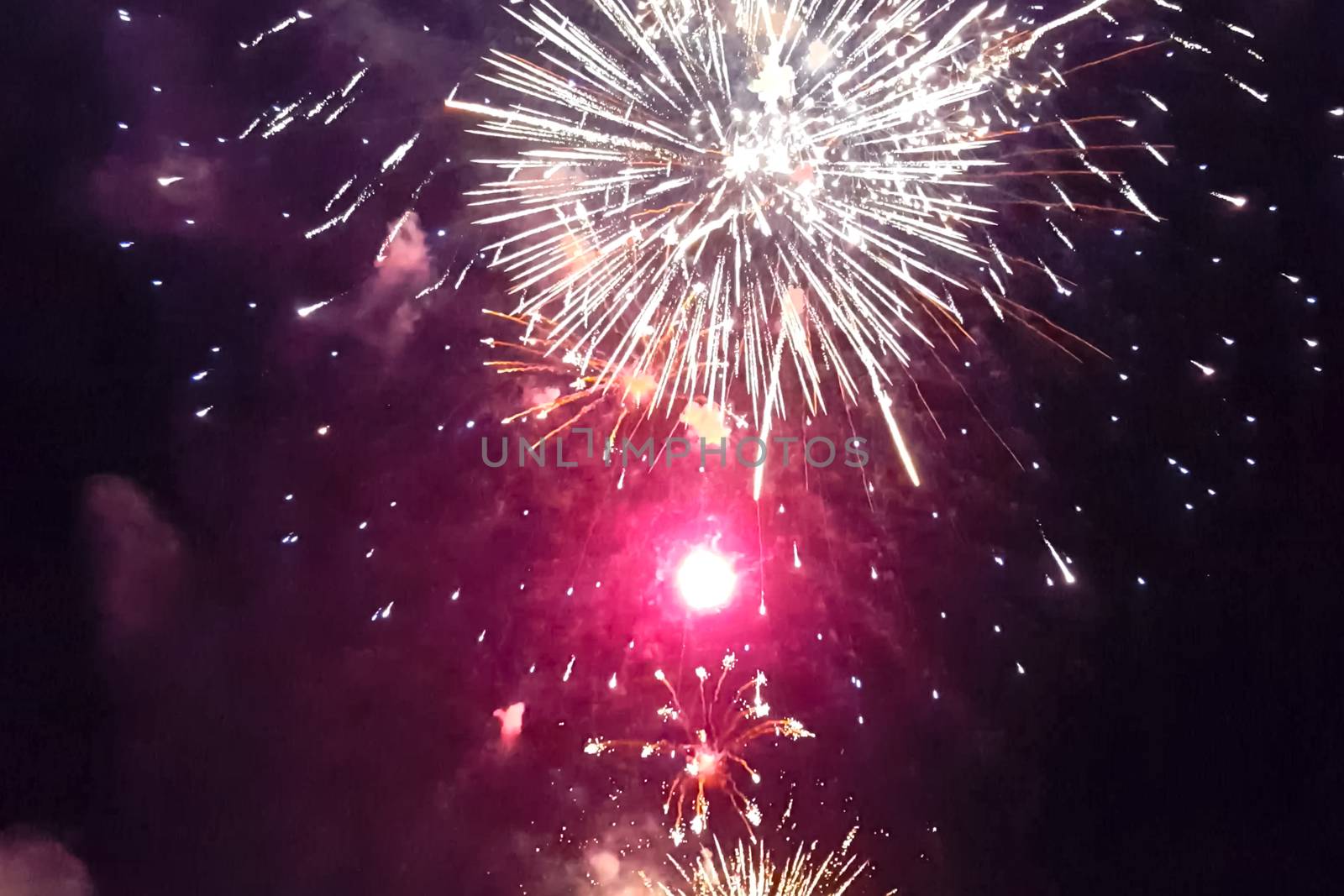 Festive salute in the night sky. Explosions of fireworks.