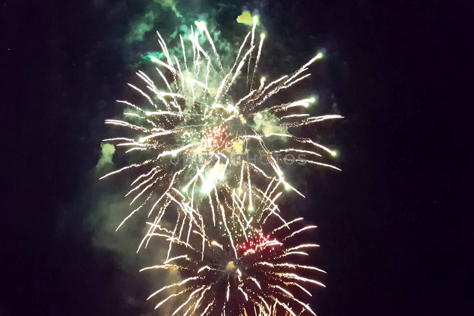 Festive salute in the night sky. Explosions of fireworks.