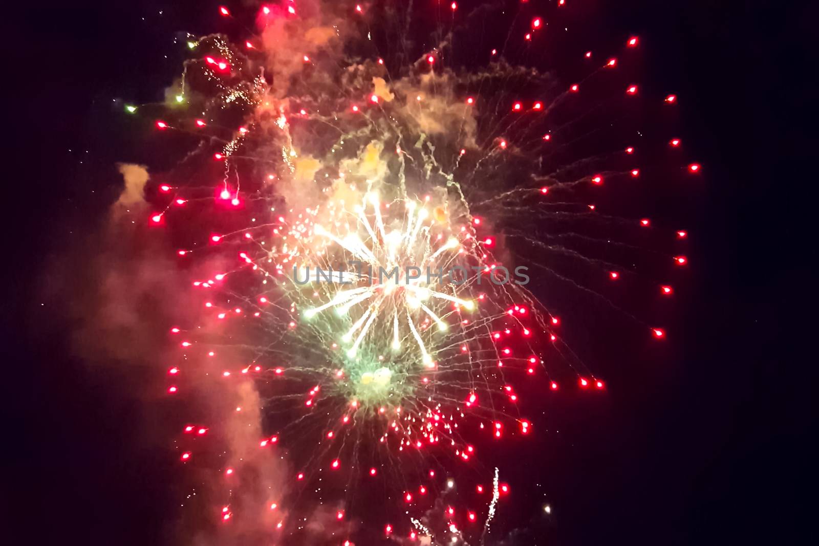 Festive salute in the night sky. Explosions of fireworks.