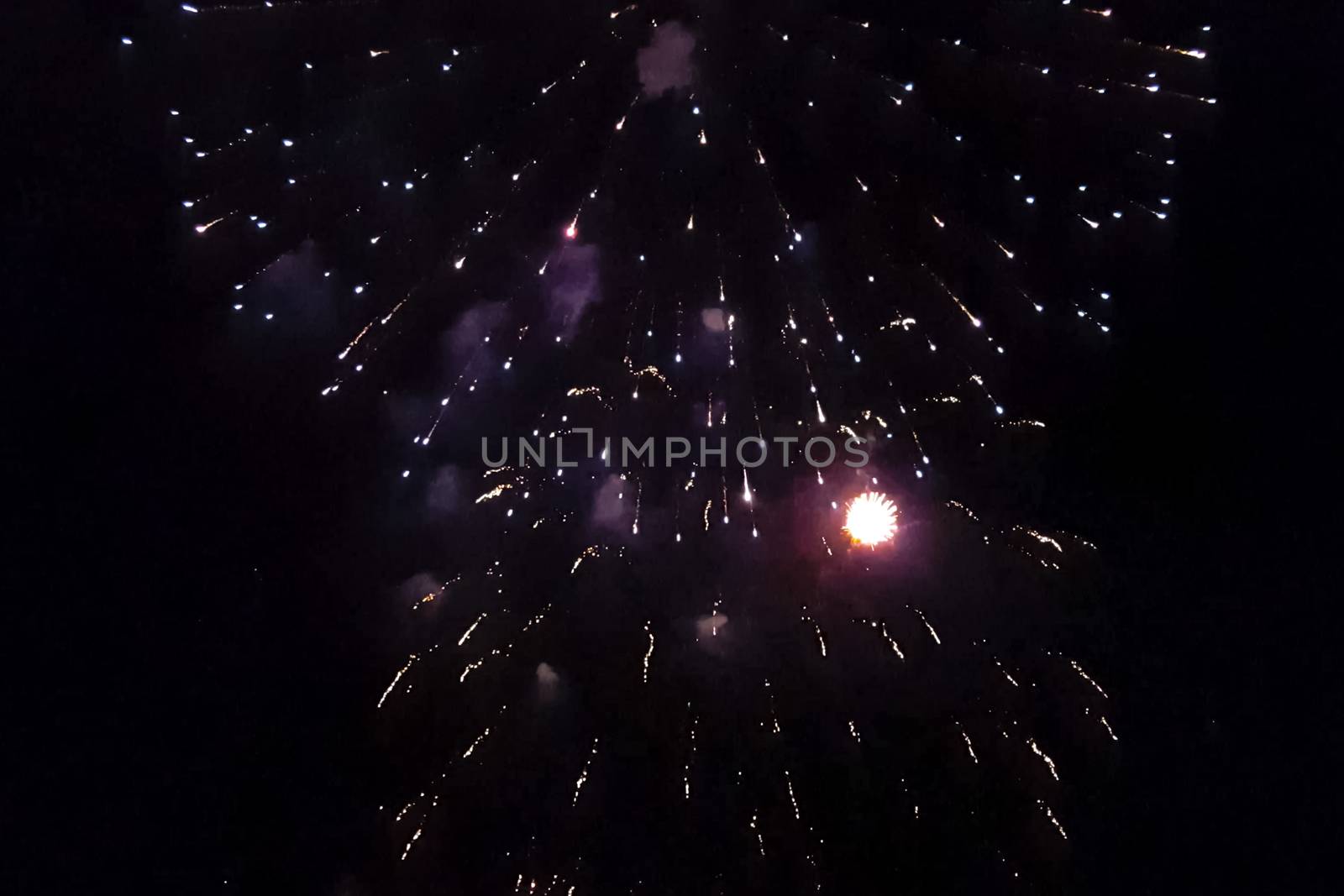 Festive salute in the night sky. Explosions of fireworks.