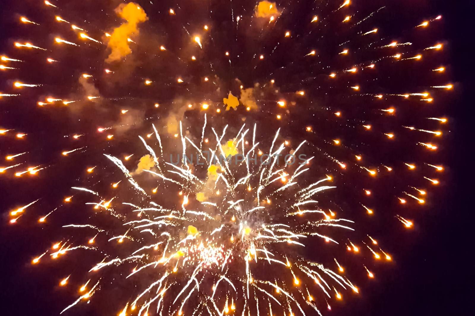 Festive salute in the night sky. Explosions of fireworks.