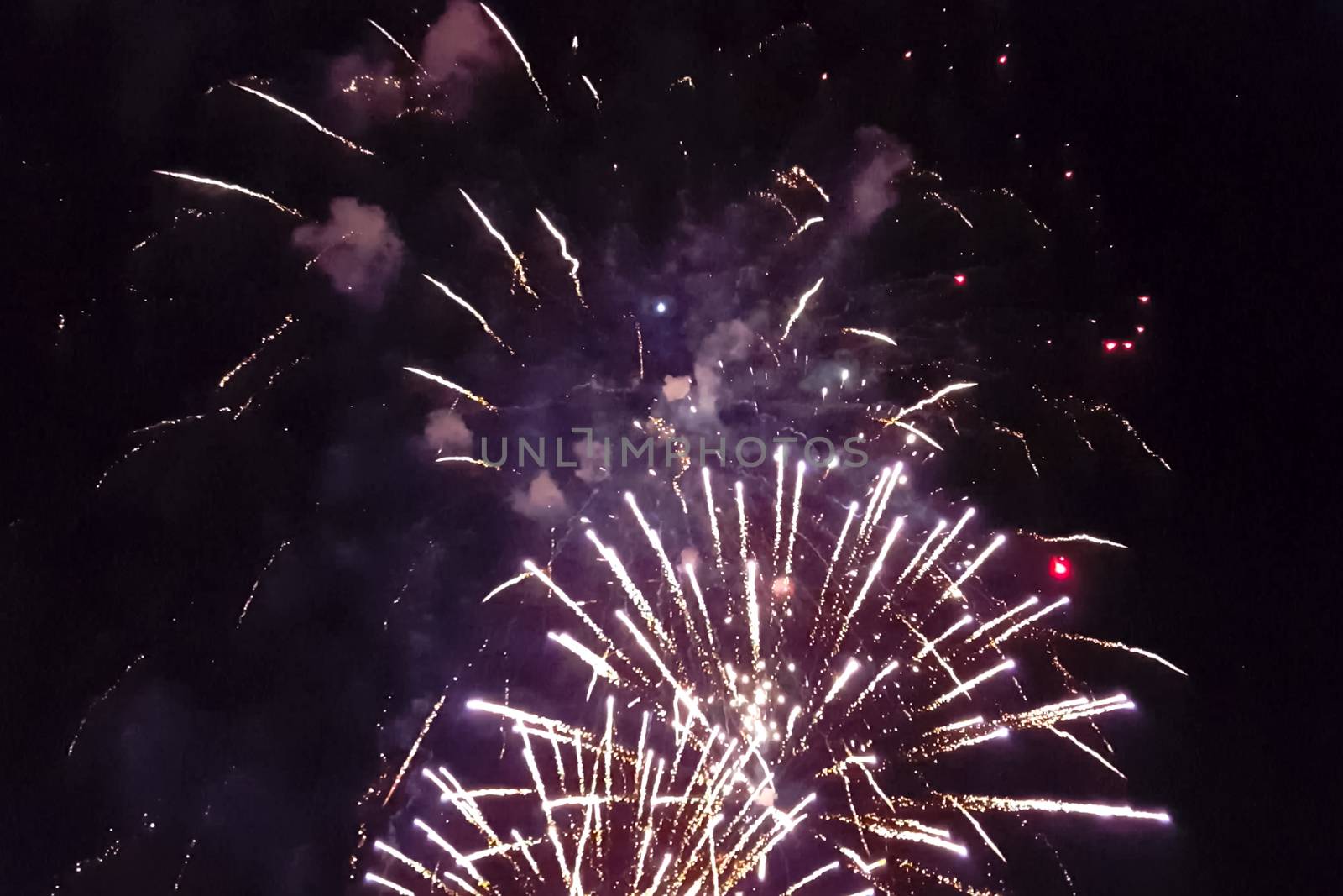 Festive salute in the night sky. Explosions of fireworks.