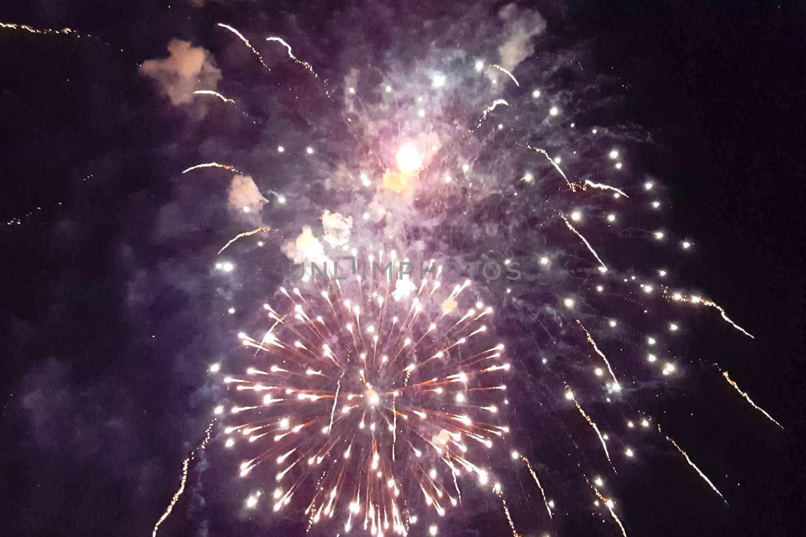 Festive salute in the night sky. Explosions of fireworks.